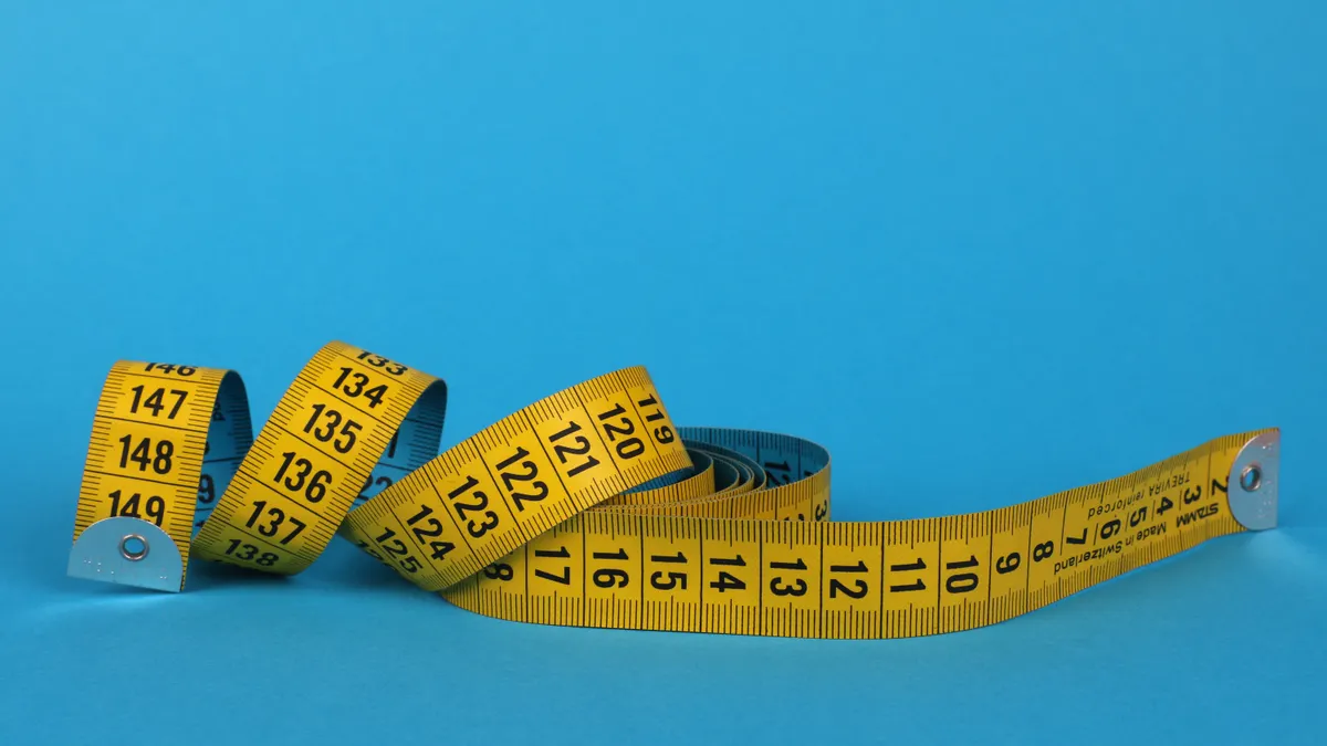 How to measure local SEO performance for a small business How to measure local SEO performance for a small business — Yellow and Black Tape Measure on Blue Background